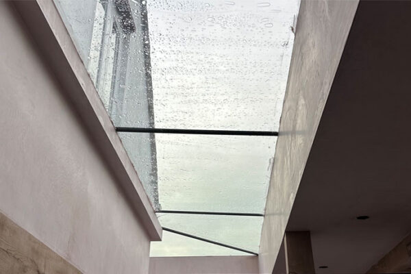 a glass roof light with raindrops on it