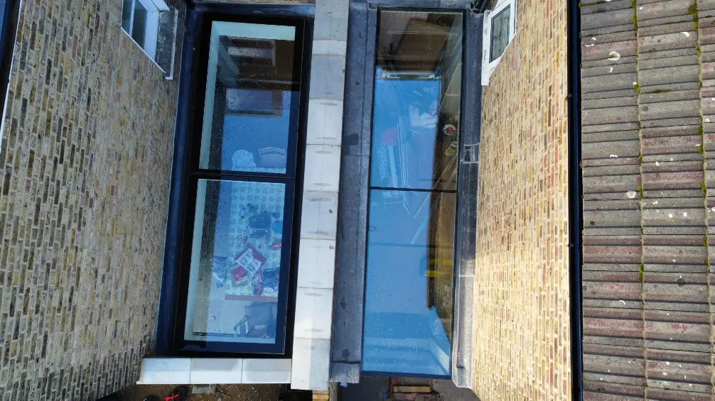 Top view of Flat Rooflight around brick wall